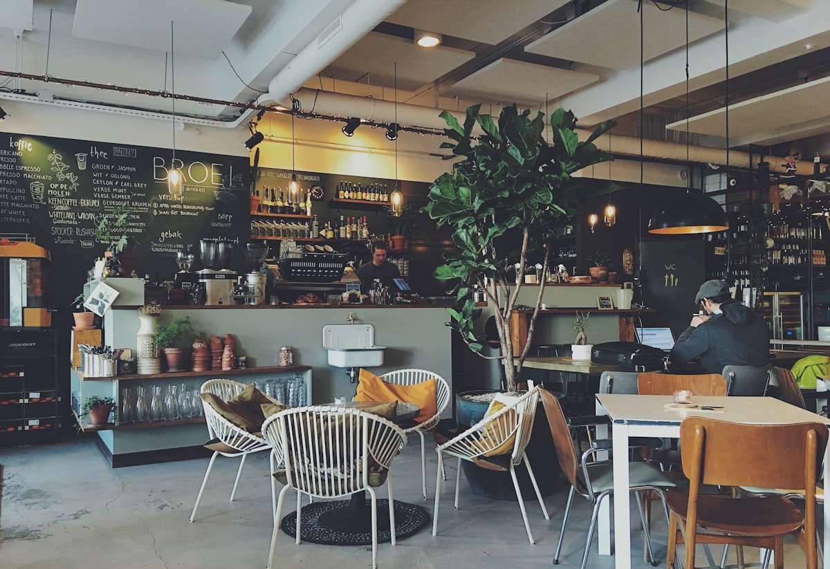 Coffee shop ceiling fan spinning above empty tables at lunch